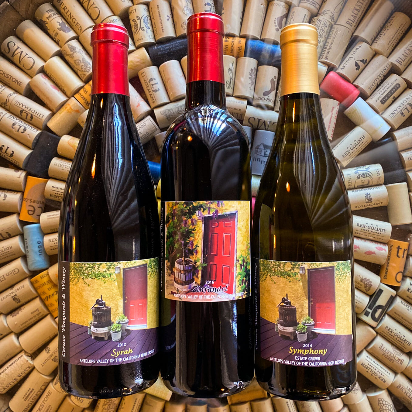 Syrah, Zinfandel, and Symphony wine bottles